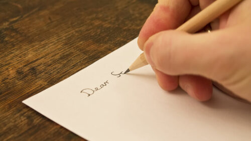 stock image of a man writing a letter