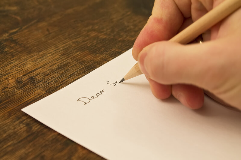 stock image of a man writing a letter