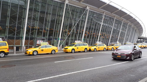 Taxis parking next to the airport terminal at John F. Kennedy International Airport.